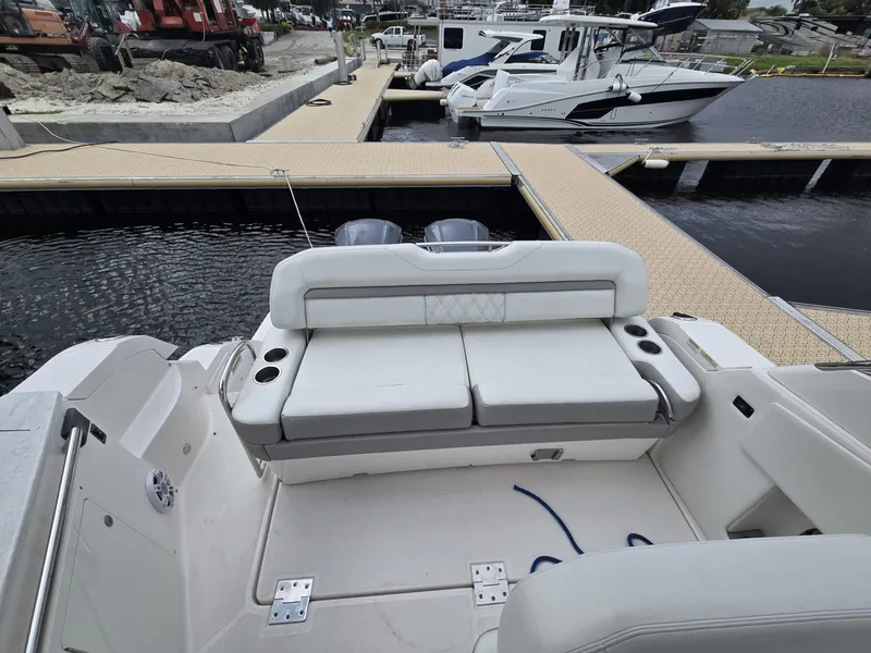 Slide: The Image of 2020 Regal 33 XO boat with spacious seating at a marina dock. - 6