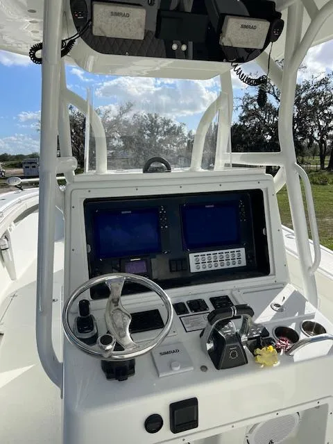 Slide: The Image of 2010 Yellowfin 36 boat dashboard with navigation screens and steering wheel. - 10
