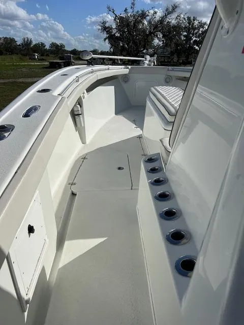 Slide: The Image of 2010 Yellowfin 36 boat deck with rod holders and seating under a blue sky. - 11