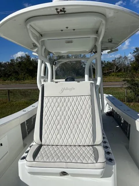 Slide: The Image of 2010 Yellowfin 36 boat with cushioned seating and center console. - 12