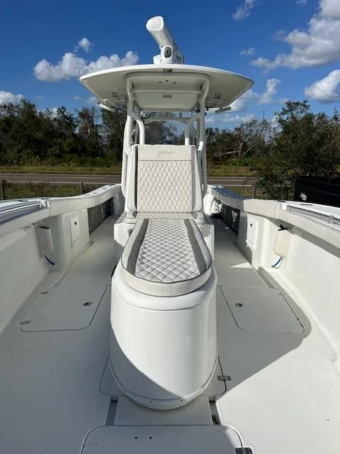 Slide: The Image of 2010 Yellowfin 36 boat with sleek white design and cushioned seating. - 13