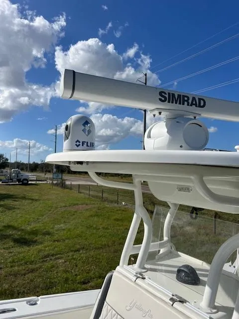 Slide: The Image of 2010 Yellowfin 36 boat with Simrad and FLIR equipment under a blue sky. - 17