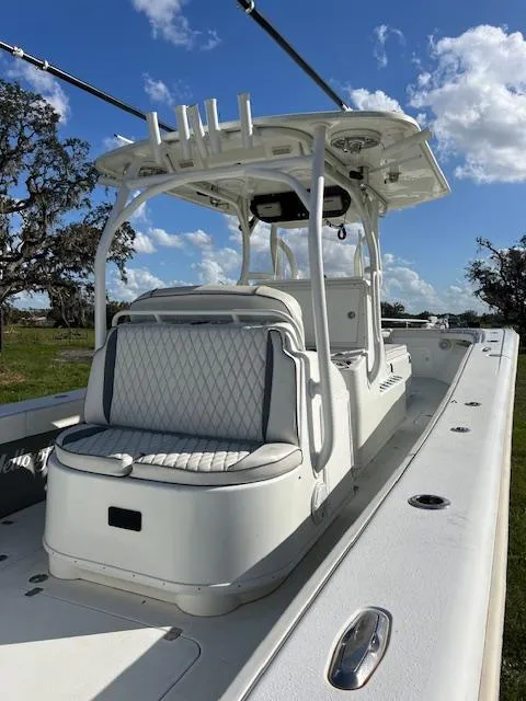 Slide: The Image of 2010 Yellowfin 36 boat with white seating and T-top under blue sky. - 18
