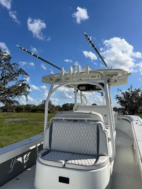 Slide: The Image of 2010 Yellowfin 36 boat with fishing rods, white seating, and clear blue sky. - 19