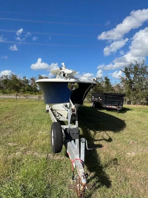 Slide: The Image of 2010 Yellowfin 36 boat on trailer under blue sky. - 2