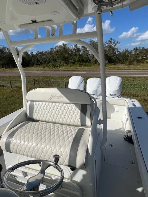 Slide: The Image of 2010 Yellowfin 36 boat interior with white seating and triple engines. - 8
