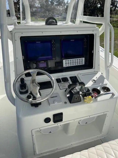 Slide: The Image of 2010 Yellowfin 36 boat console with dual screens and steering wheel. - 9
