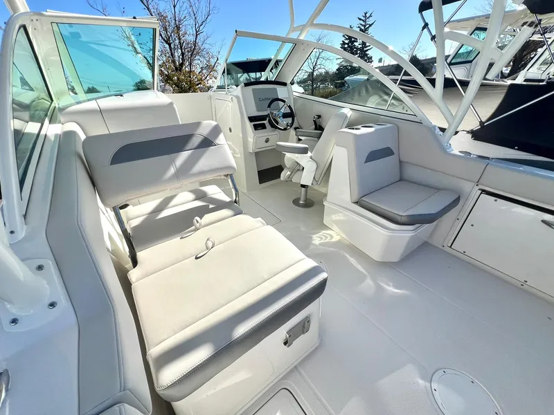 Slide: The Image of 2025 Sailfish 245 DC boat interior with seating and steering console. - 10