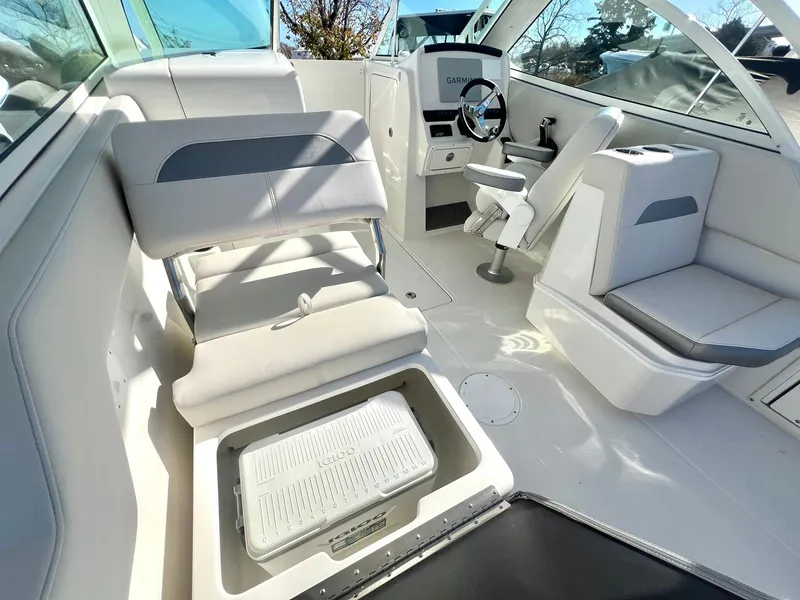 Slide: The Image of 2025 Sailfish 245 DC boat interior with seating and steering wheel. - 11