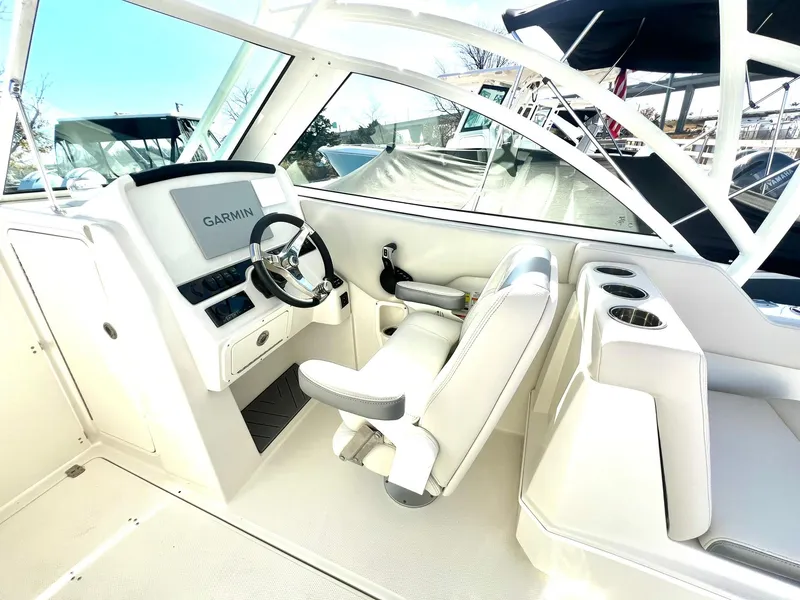 Slide: The Image of 2025 Sailfish 245 DC boat interior with Garmin navigation system and comfortable seating. - 15