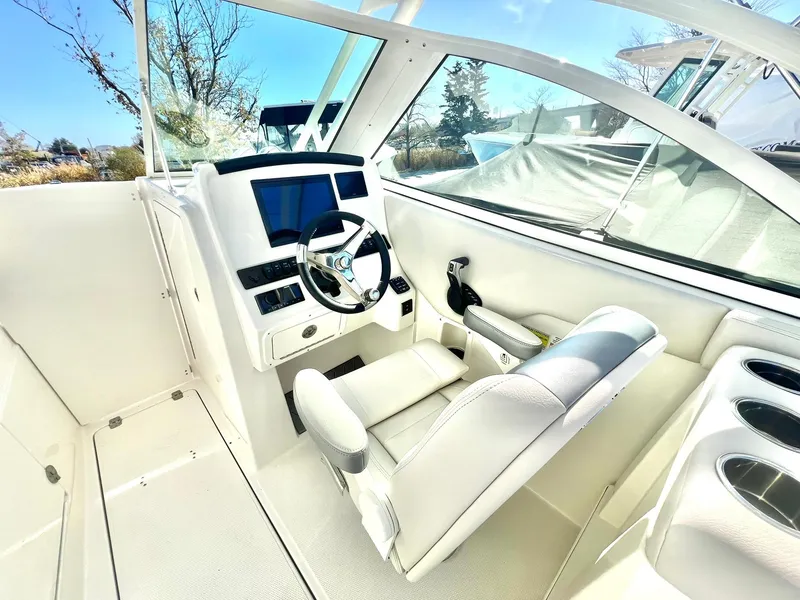 Slide: The Image of 2025 Sailfish 245 DC boat interior with modern helm and comfortable seating. - 18