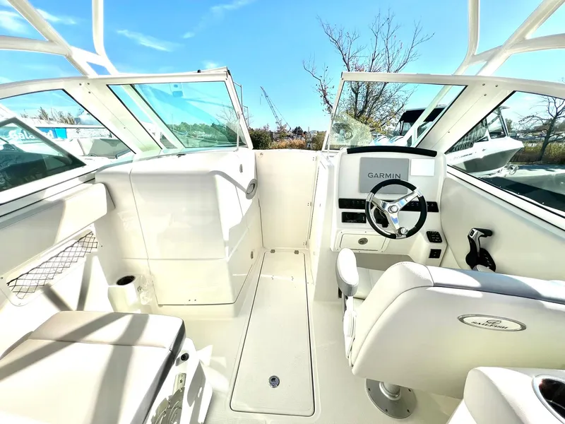 Slide: The Image of 2025 Sailfish 245 DC boat interior with Garmin navigation system and comfortable seating. - 21