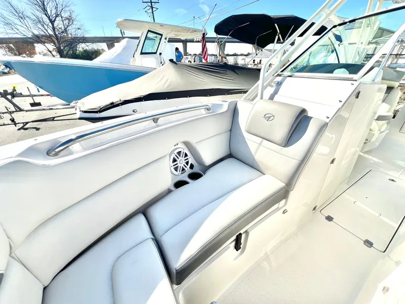 Slide: The Image of 2025 Sailfish 245 DC boat interior with white seating and speaker. - 24