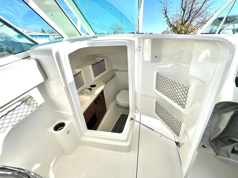 Slide: The Image of 2025 Sailfish 245 DC boat interior with compact cabin and amenities. - 27