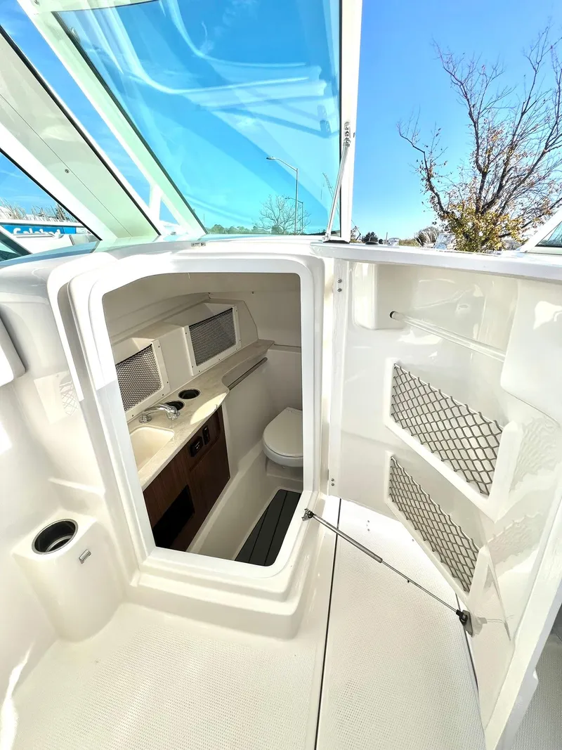 Slide: The Image of 2025 Sailfish 245 DC boat interior with compact cabin and modern amenities. - 28