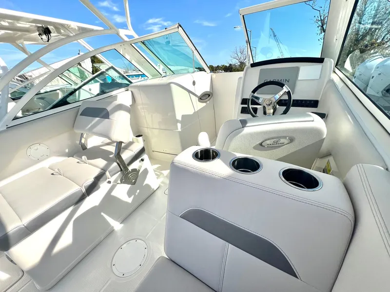 Slide: The Image of 2025 Sailfish 245 DC boat interior with modern seating and steering wheel. - 4