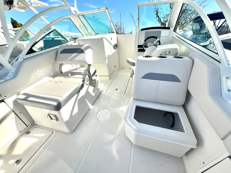 Slide: The Image of 2025 Sailfish 245 DC boat interior with white seating and modern design. - 5