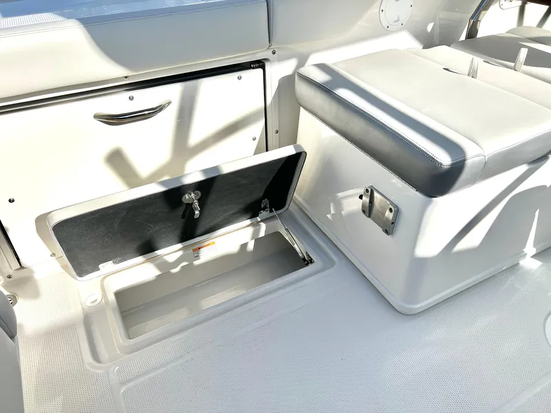 Slide: The Image of 2025 Sailfish 245 DC boat interior with storage compartments and seating. - 7