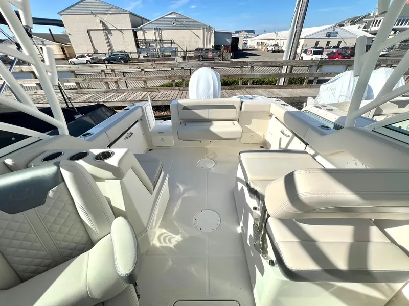 Slide: The Image of 2025 Sailfish 245 DC boat interior with white seating and cup holders. - 9