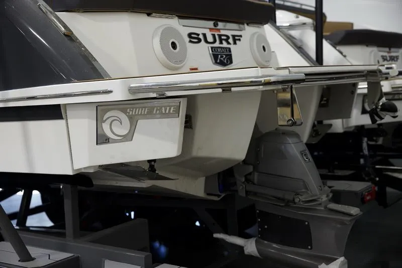 Slide: The Image of 2025 Cobalt R6 Surf boat with Surf Gate technology, rear view in showroom. - 5