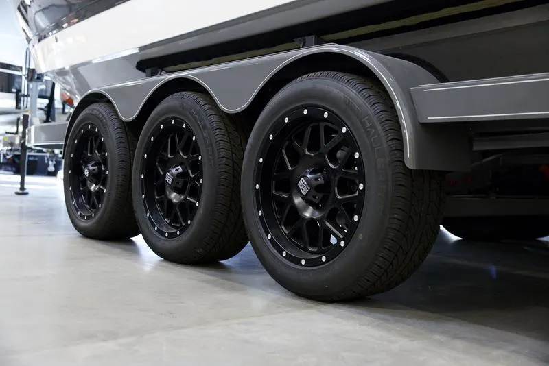 Slide: The Image of 2025 Cobalt R6 Surf trailer with black alloy wheels in a showroom. - 6