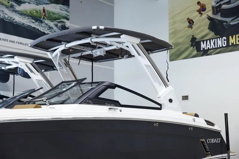 Slide: The Image of 2025 Cobalt R6 Surf boat in showroom, sleek design with modern features. - 7