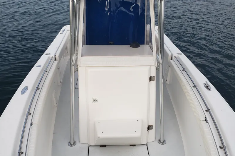 Slide: The Image of 1999 Silverhawk 24 boat, white deck, blue console, on calm water. - 11