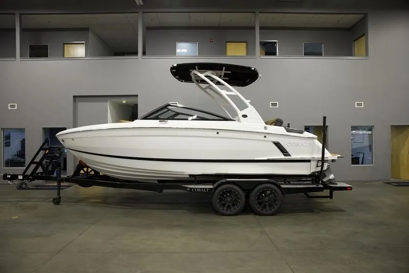 Slide: The Image of 2025 Cobalt R4 Surf boat on trailer in showroom. - 0