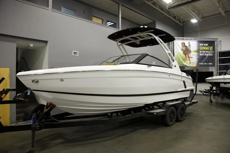 Slide: The Image of 2025 Cobalt R4 Surf boat on trailer in indoor showroom. - 1
