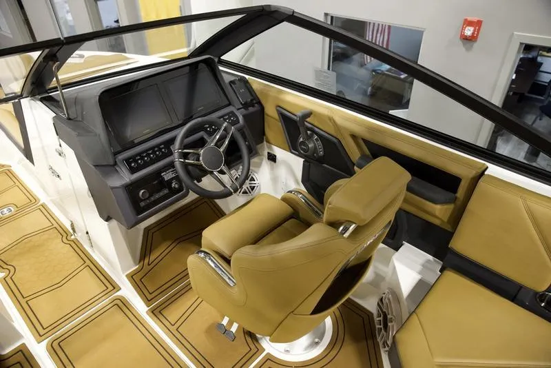 Slide: The Image of 2025 Cobalt R4 Surf boat interior with tan seating and modern dashboard. - 10
