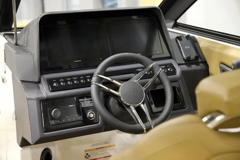 Slide: The Image of 2025 Cobalt R4 Surf boat dashboard with modern steering wheel and digital displays. - 11