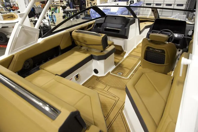 Slide: The Image of Luxurious interior of 2025 Cobalt R4 Surf boat with tan seating and modern dashboard. - 12