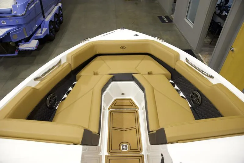 Slide: The Image of 2025 Cobalt R4 Surf boat interior with tan seating and modern design. - 13