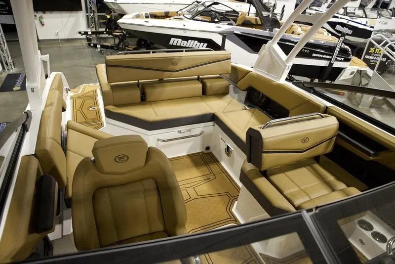Slide: The Image of 2025 Cobalt R4 Surf boat interior with tan leather seating and modern design. - 14