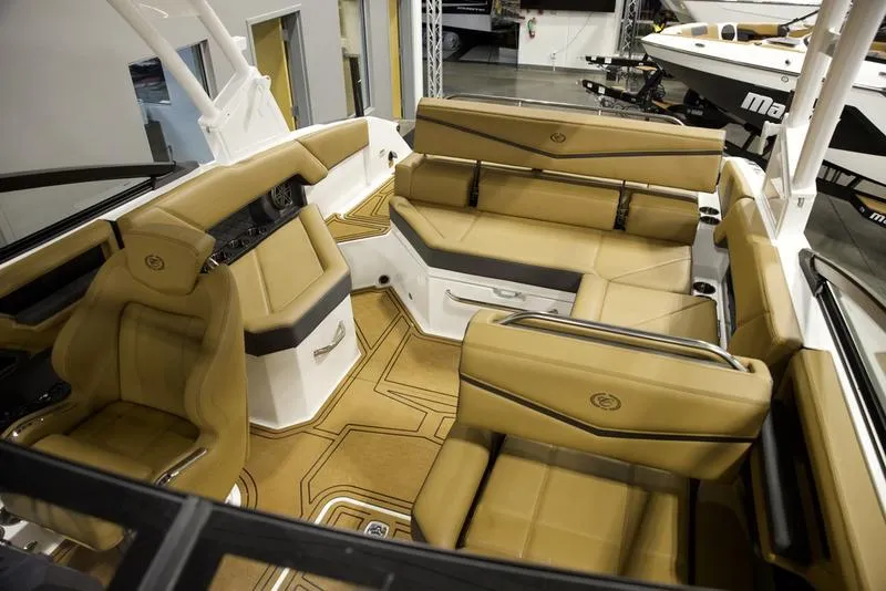 Slide: The Image of Luxurious interior of 2025 Cobalt R4 Surf boat with tan leather seating. - 16