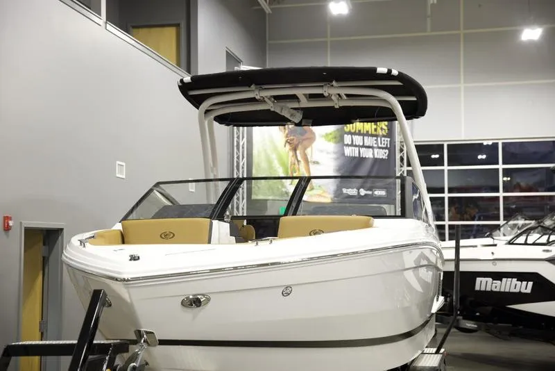 Slide: The Image of 2025 Cobalt R4 Surf boat displayed indoors with sleek design and modern features. - 7