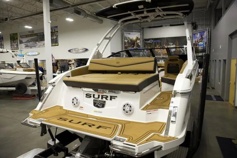 Slide: The Image of 2025 Cobalt R4 Surf boat in showroom, featuring sleek design and comfortable seating. - 8