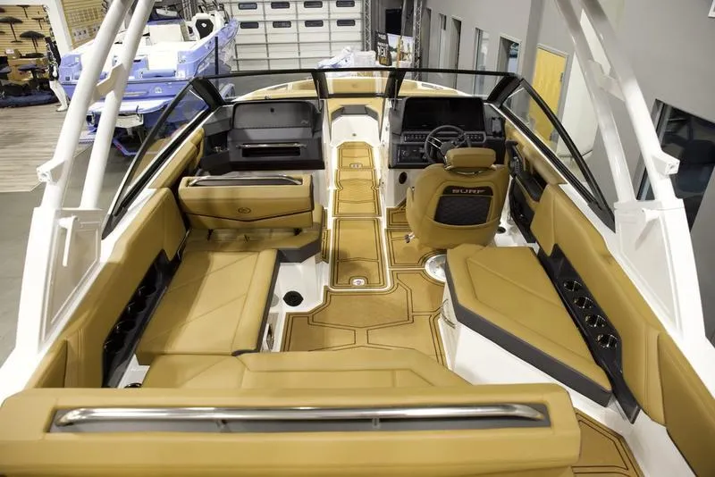 Slide: The Image of 2025 Cobalt R4 Surf boat interior with tan seating and modern dashboard. - 9