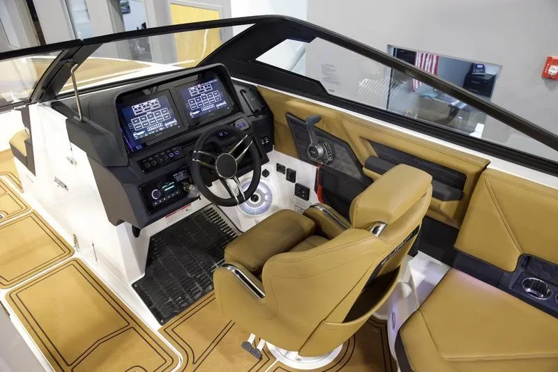 Slide: The Image of 2025 Cobalt R8 Surf boat interior with modern dashboard and tan seating. - 11