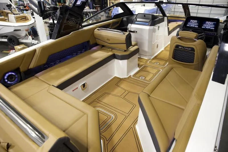Slide: The Image of Luxurious interior of 2025 Cobalt R8 Surf boat with tan seating and modern dashboard. - 12