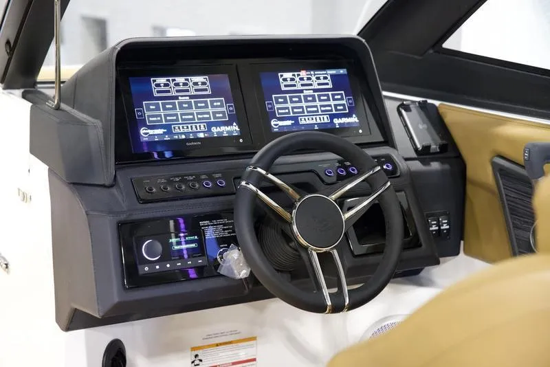 Slide: The Image of 2025 Cobalt R8 Surf boat dashboard with dual touchscreens and modern steering wheel. - 13