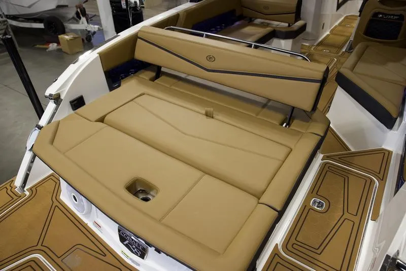 Slide: The Image of 2025 Cobalt R8 Surf boat interior with tan seating and sleek design. - 9