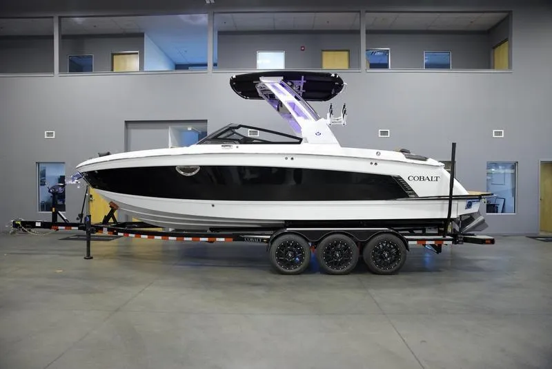 Slide: The Image of 2025 Cobalt R8 Surf boat on trailer in showroom. - 1