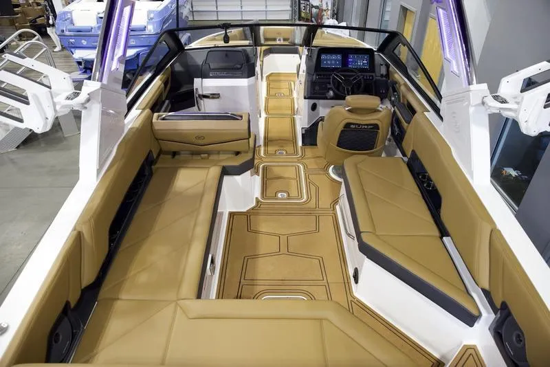 Slide: The Image of 2025 Cobalt R8 Surf boat interior with tan seating and modern dashboard. - 10