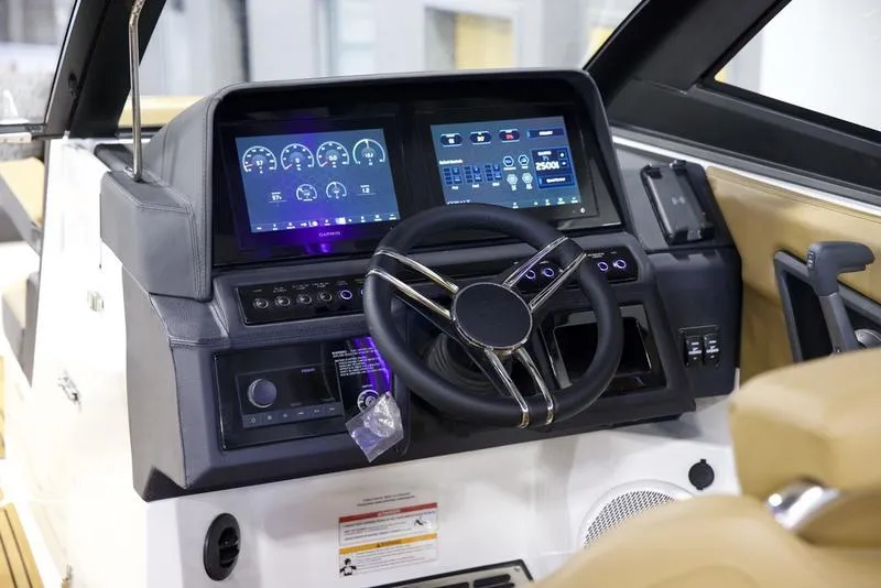 Slide: The Image of 2025 Cobalt R8 Surf boat dashboard with dual digital displays and modern steering wheel. - 13