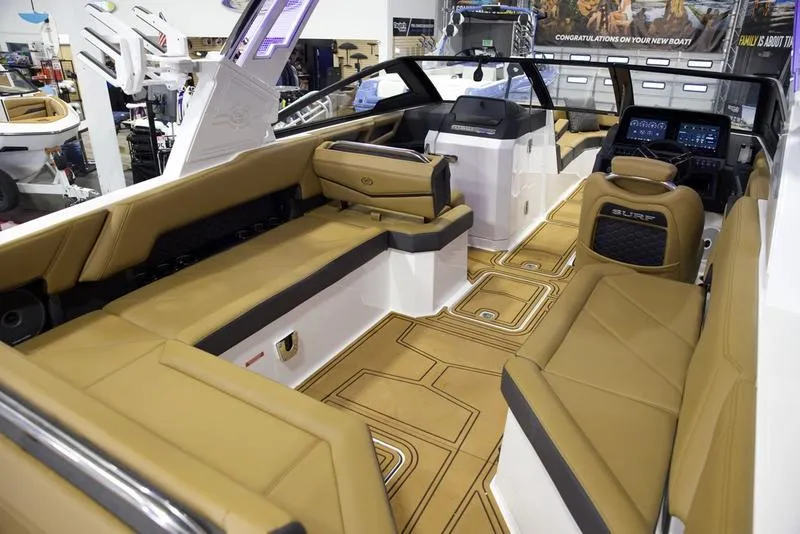 Slide: The Image of 2025 Cobalt R8 Surf boat interior with tan leather seating and modern dashboard. - 15