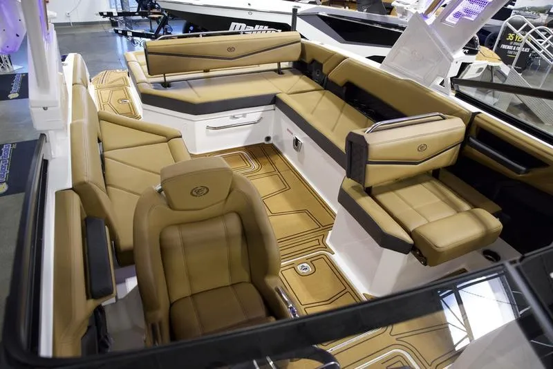 Slide: The Image of 2025 Cobalt R8 Surf boat interior with luxurious tan seating and modern design. - 16
