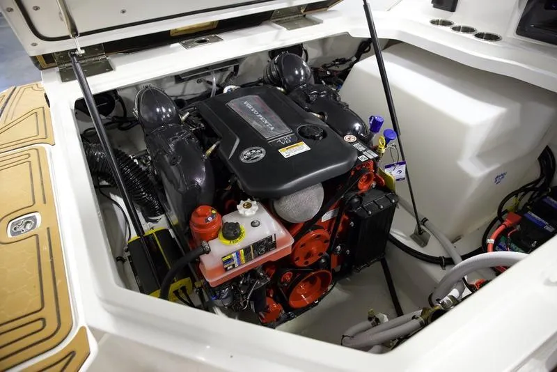 Slide: The Image of 2025 Cobalt R8 Surf boat engine compartment with detailed components. - 2