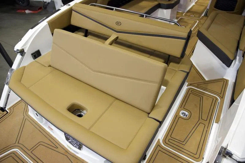 Slide: The Image of 2025 Cobalt R8 Surf boat interior with tan seating and sleek design. - 21