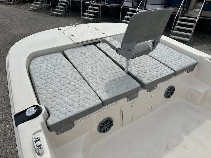 Slide: The Image of 2025 Carolina Skiff 21 LS boat with cushioned seating and storage compartments. - 11